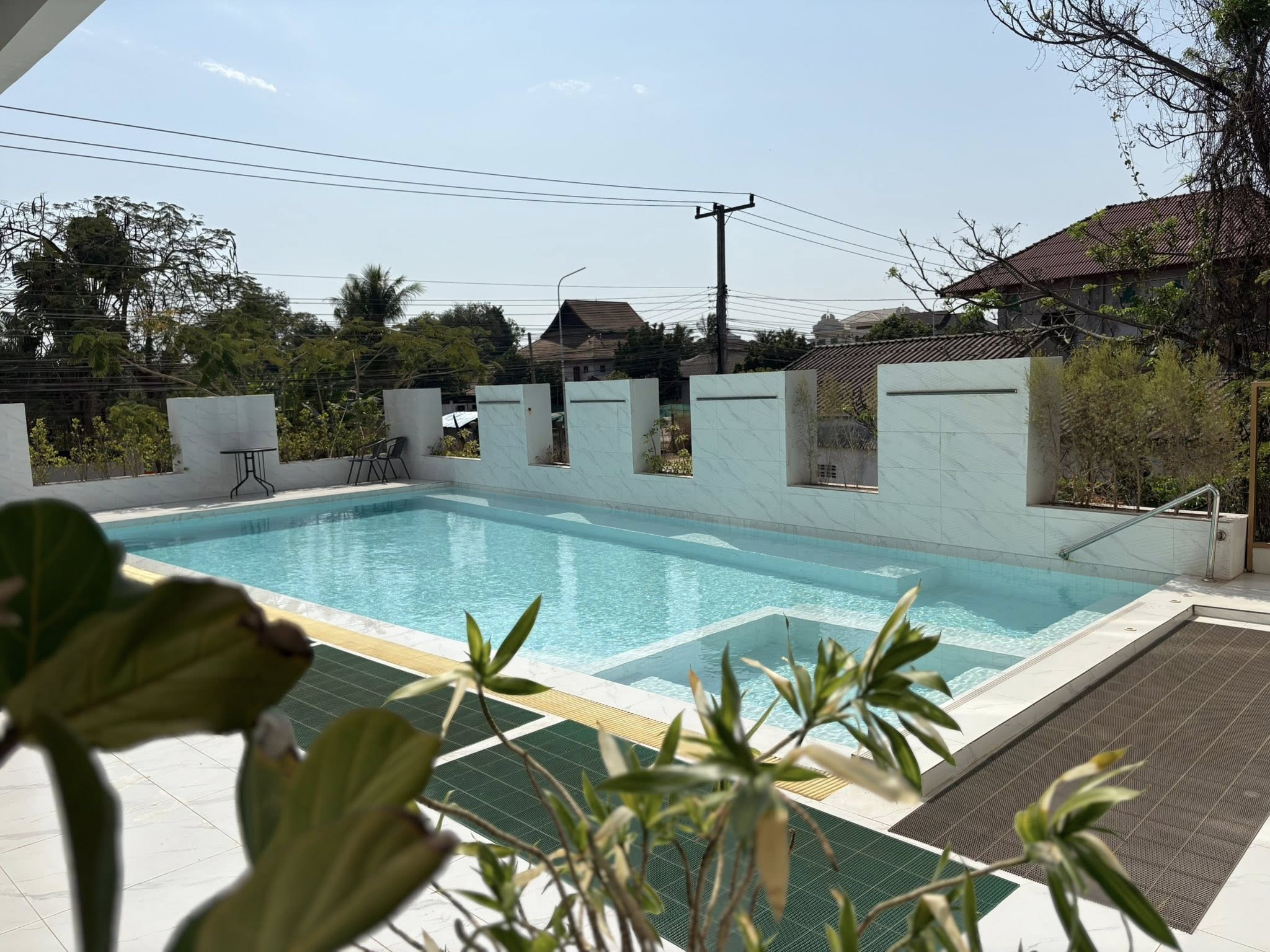 Resort-style swimming pool with sun loungers